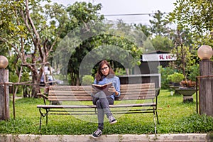 Beautiful girl reading books in the garden