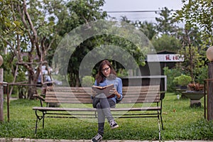 Beautiful girl reading books in the garden