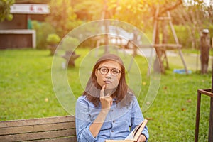 Beautiful girl reading books in the garden