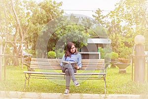 Beautiful girl reading books in the garden