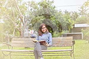 Beautiful girl reading books in the garden