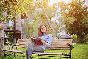 Beautiful girl reading books in the garden