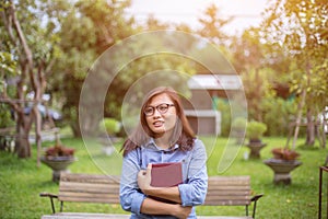 Beautiful girl reading books in the garden