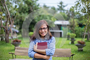 Beautiful girl reading books in the garden