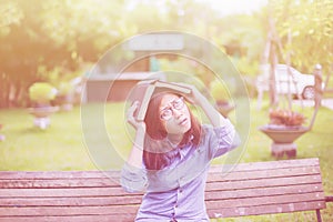 Beautiful girl reading books in the garden