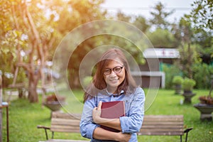 Beautiful girl reading books in the garden