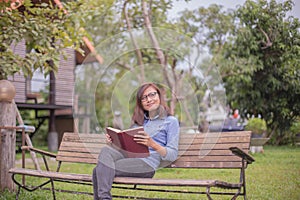 Beautiful girl reading books in the garden photo