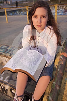 Beautiful girl reading holy bible