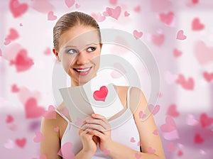 Beautiful girl reads a postcard valentine photo