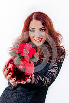 Beautiful girl with a red Christmas ball in her hands