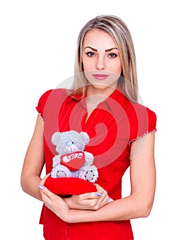 Beautiful girl in red clothes with bear on white background