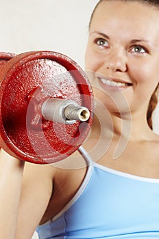 Beautiful girl and red dumbbell