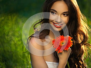 Beautiful Girl With Red Flowers. Beautiful Model Woman Face.