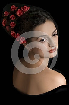 Beautiful girl with red flowers in hairs