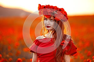 Beautiful girl in red poppy field at sunset. Beuaty makeup. Free