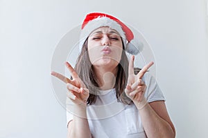 Beautiful girl in red Santa Claus hat isolated on white background. Winter portrait of young woman. Happy Christmas and New Year