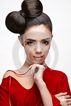 Beautiful girl in a red shirt and shiny hearts on her cheek. Model with a bow on her head and Nude makeup