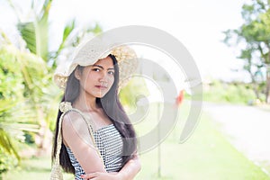 Beautiful girl relaxing on a resort wearing a straw hat