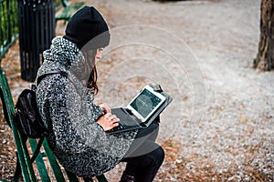 Beautiful girl researching on her tablet in a park