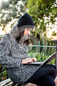 Beautiful girl researching on her tablet in a park - close up