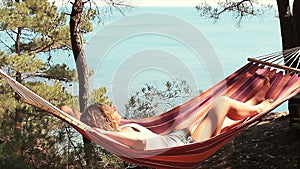 Beautiful girl resting in a hammock