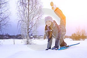 Beautiful girl rides downhill in winter. Artistically colored photography