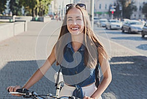 Beautiful girl riding on bike outdoor