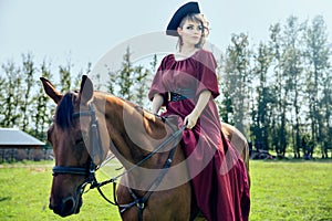 Beautiful girl riding a brown horse.