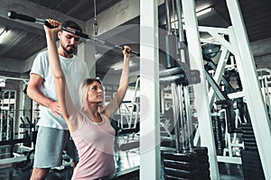 Beautiful Girl is Rowing Exercise With Bodybuilder Equipment in Fitness Club.,Portrait of Strong Woman doing Working Out Calories