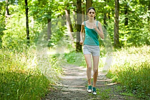 Beautiful girl running through forest