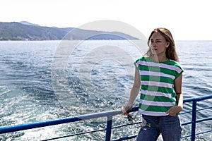 A beautiful girl is sailing on a ship on lake Baikal