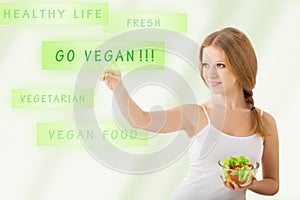 Beautiful girl with a salad choose vegetarianism photo