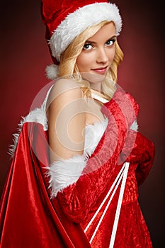 Beautiful girl with Santa Claus gift bag