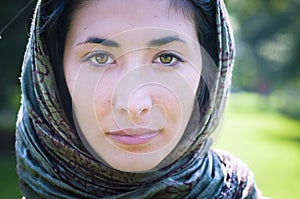 Beautiful girl with scarf safi on the lawn