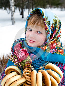 Beautiful girl in scarf on wintery background