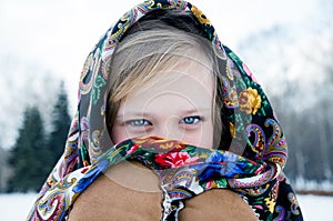 Beautiful girl in scarf on wintery background