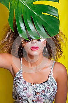 Beautiful Girl selfie with a smartphone. Beautiful young African American woman with afro hairstyle . Summer concept