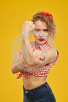 Beautiful girl with serious look showing clenched fist