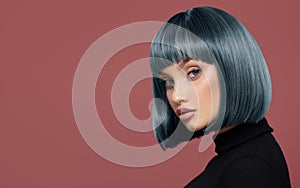 Beautiful girl with short blue hair. Pink background