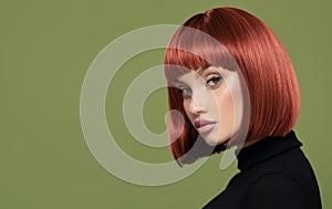Beautiful girl with short red hair. Green background