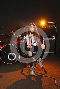 Beautiful girl singing in recording studio