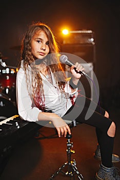 Beautiful girl singing in recording studio