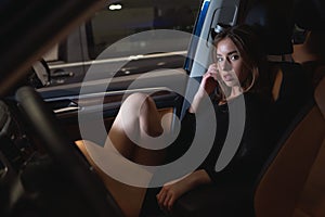 Beautiful girl in the salon of a prestigious car photo