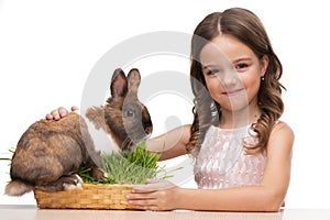 Beautiful girl sitting with cute brown bunny