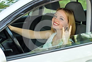 Beautiful girl sitting in a luxury car