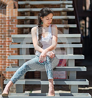 Beautiful girl sitting on stair.