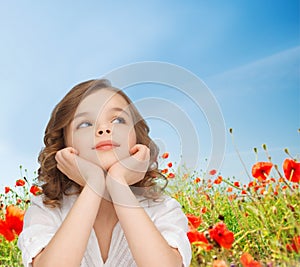 Beautiful girl sitting at table and looking up