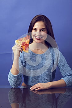 Beautiful girl with a slide of pizza