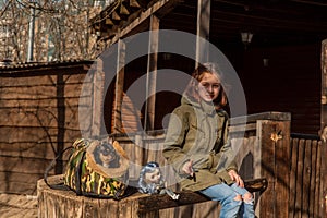 Beautiful girl with a small dog. girl on a walk with a dog and a doll. Girl playing doll. Portrait of a girl 9 years old