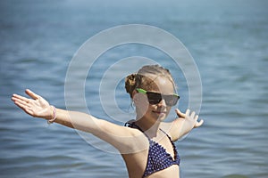 Beautiful girl smile with raised hands, woman on beach summer vacation. concept of freedom travel.